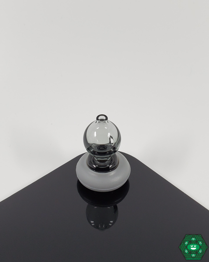  Spacewalk Glass Puffco Peak Caps placed on a table, showing their sleek and durable design, ready for use with Puffco Peak devices.