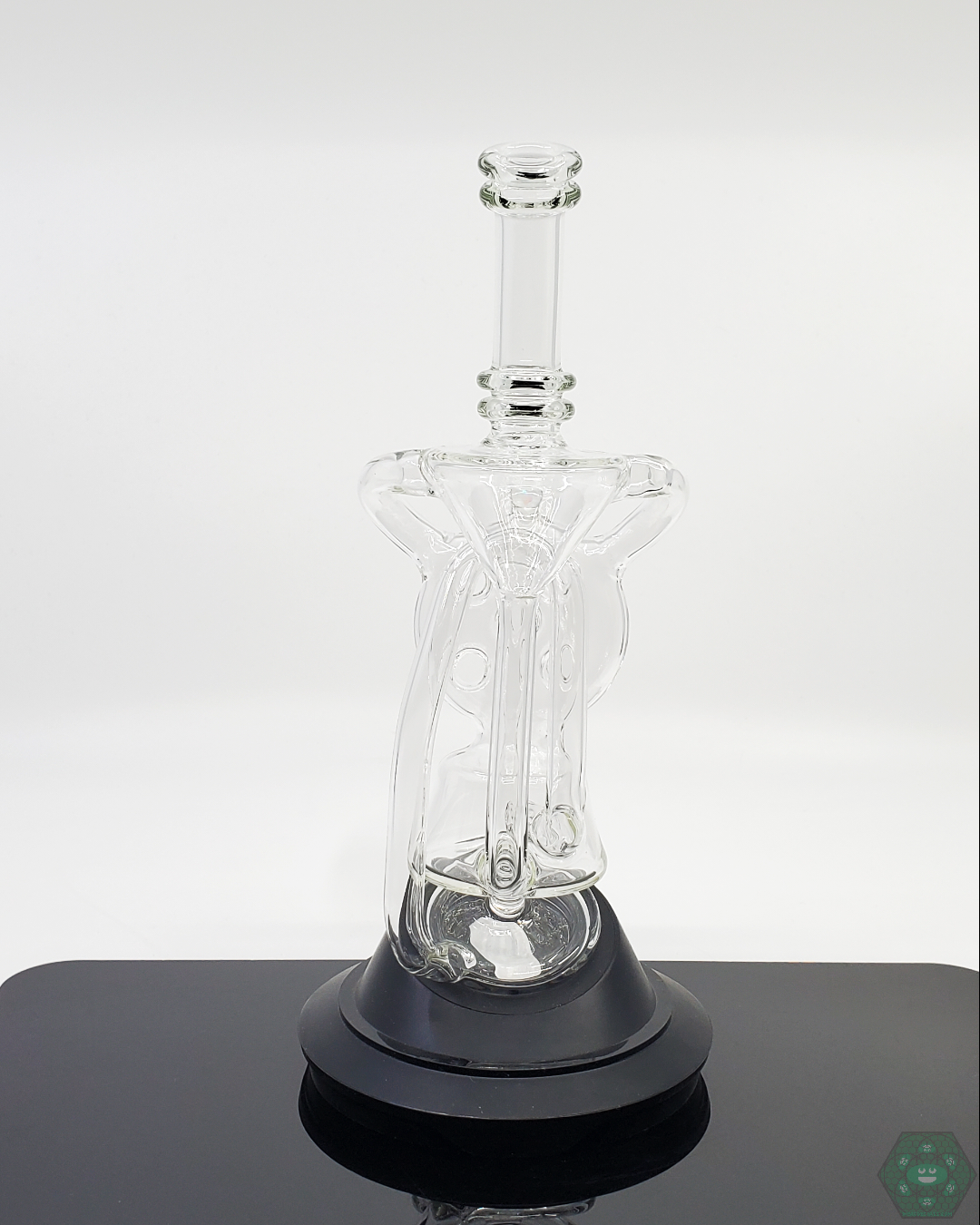 Demonstrating the Swiss Recycler attachment on a Puffco, enhancing the vapor cooling and filtration process.