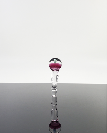 Artistic glass sculpture with a vibrant purple top and clear sculpted stem, showcasing exquisite craftsmanship and design.