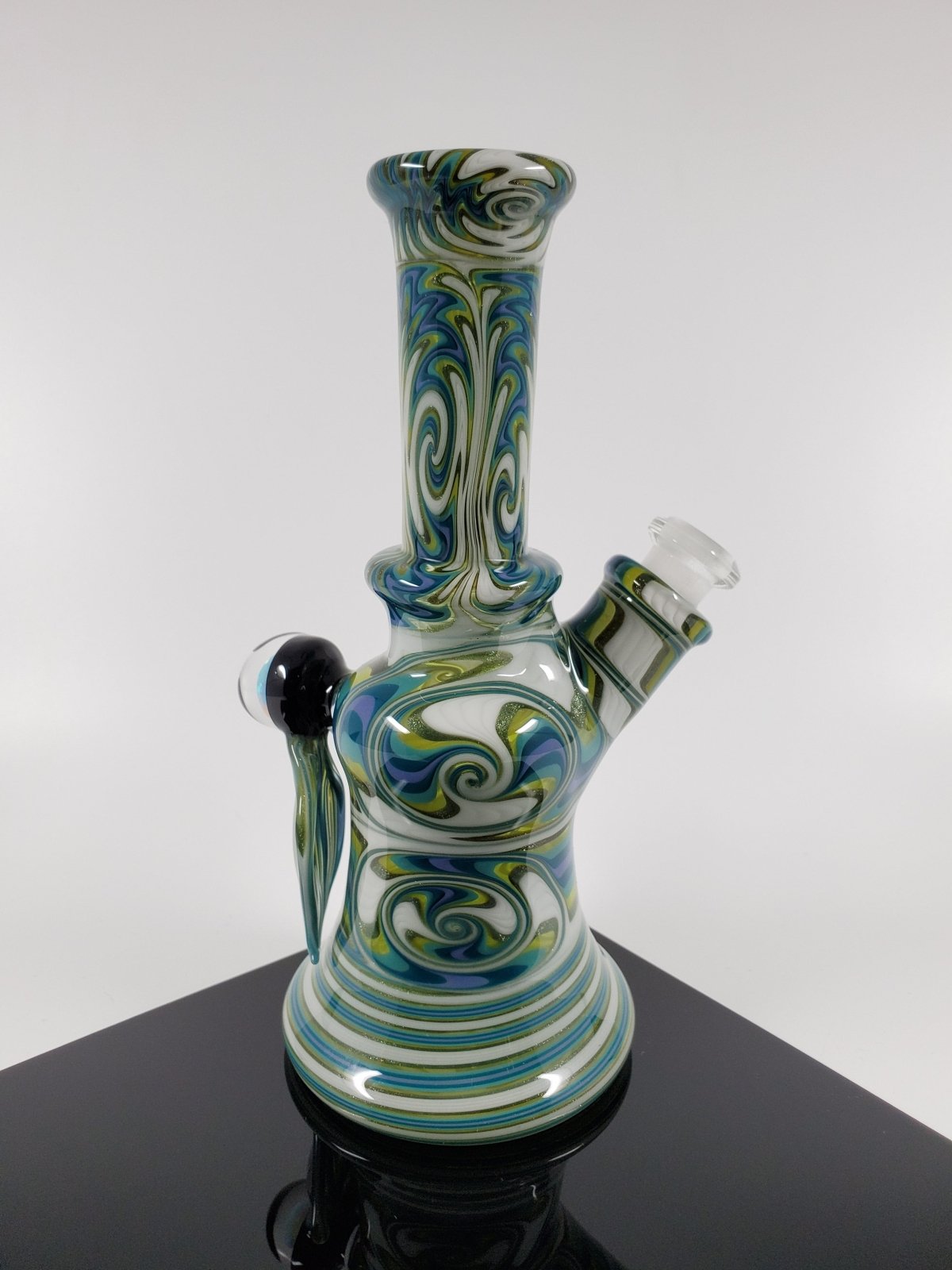 A.H. Glass White Green Mini Tube | Sturdy & Stylish | 10MM Joint. A classic and durable 10MM rig from A.H. Glass, perfect for everyday use.