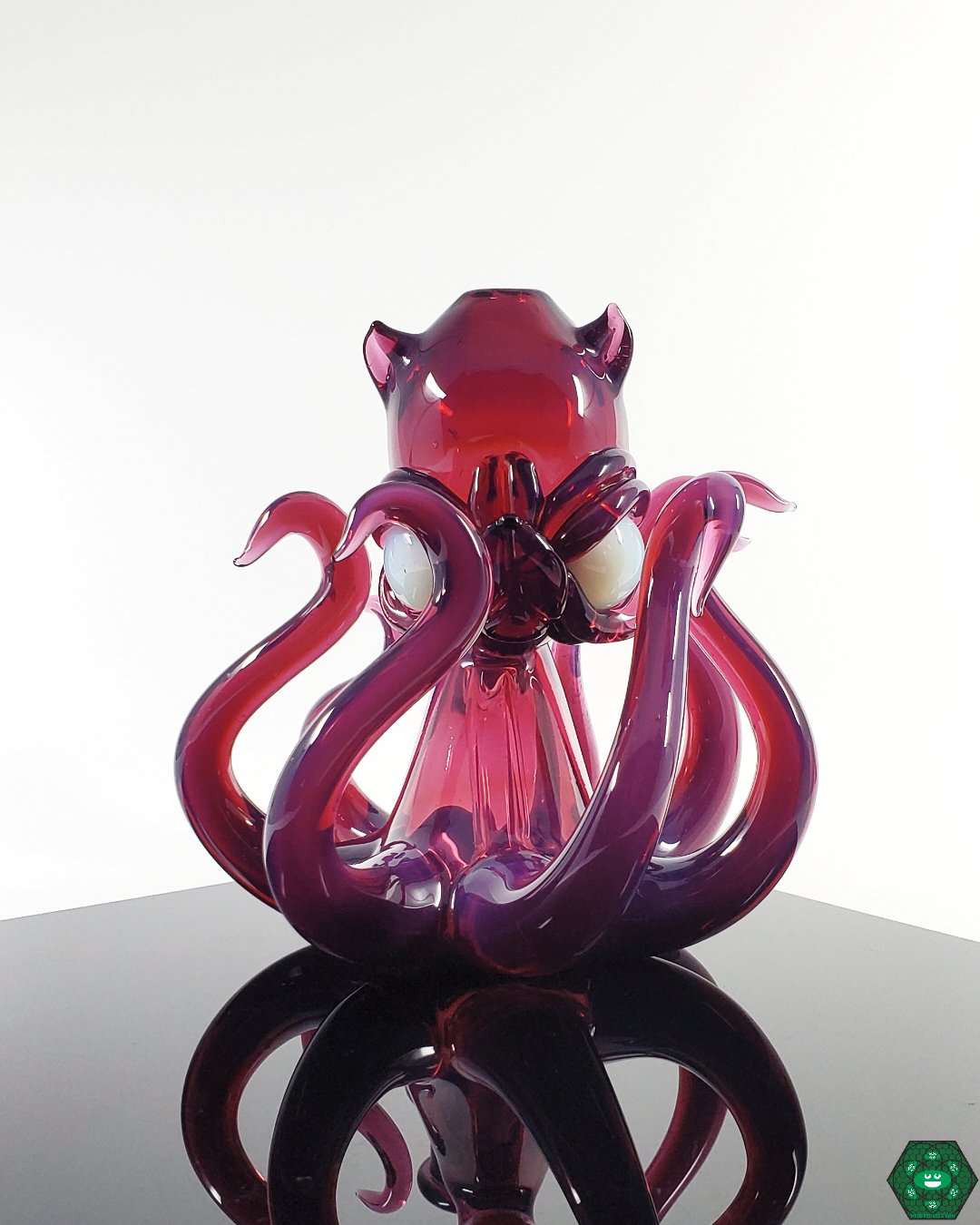 Casto Glass Octoblickey #2, a 14mm heady glass rig with a 3-hole percolator and UV accents, featuring stunning royal jelly and glopal eyes UV colors, crafted for smooth, cool hits, perfect for collectors who appreciate functionality and vibrant artistry