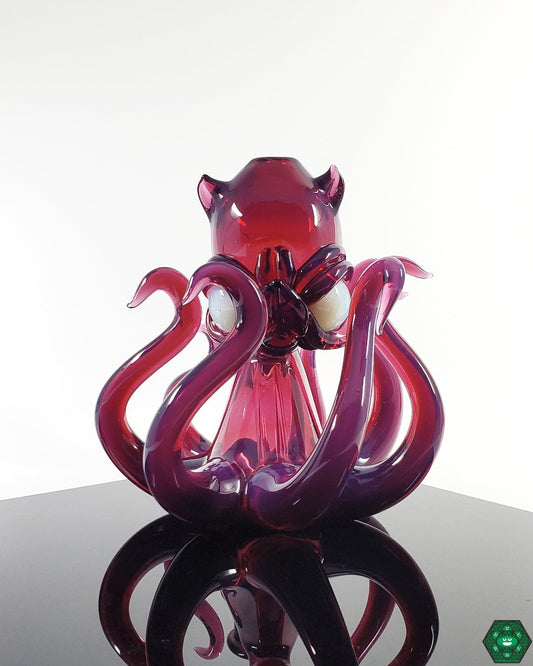 Casto Glass Octoblickey #2, a 14mm heady glass rig with a 3-hole percolator and UV accents, featuring stunning royal jelly and glopal eyes UV colors, crafted for smooth, cool hits, perfect for collectors who appreciate functionality and vibrant artistry