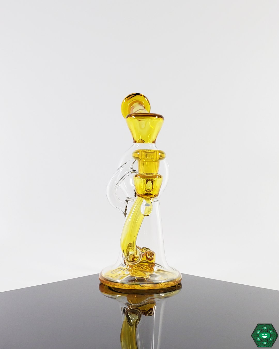  Dynamic Flow Glass Recycler: The OM Glass Co Water Slide, offering a unique flow system for smooth dabbing, combining precision and sleek design for discerning enthusiasts.