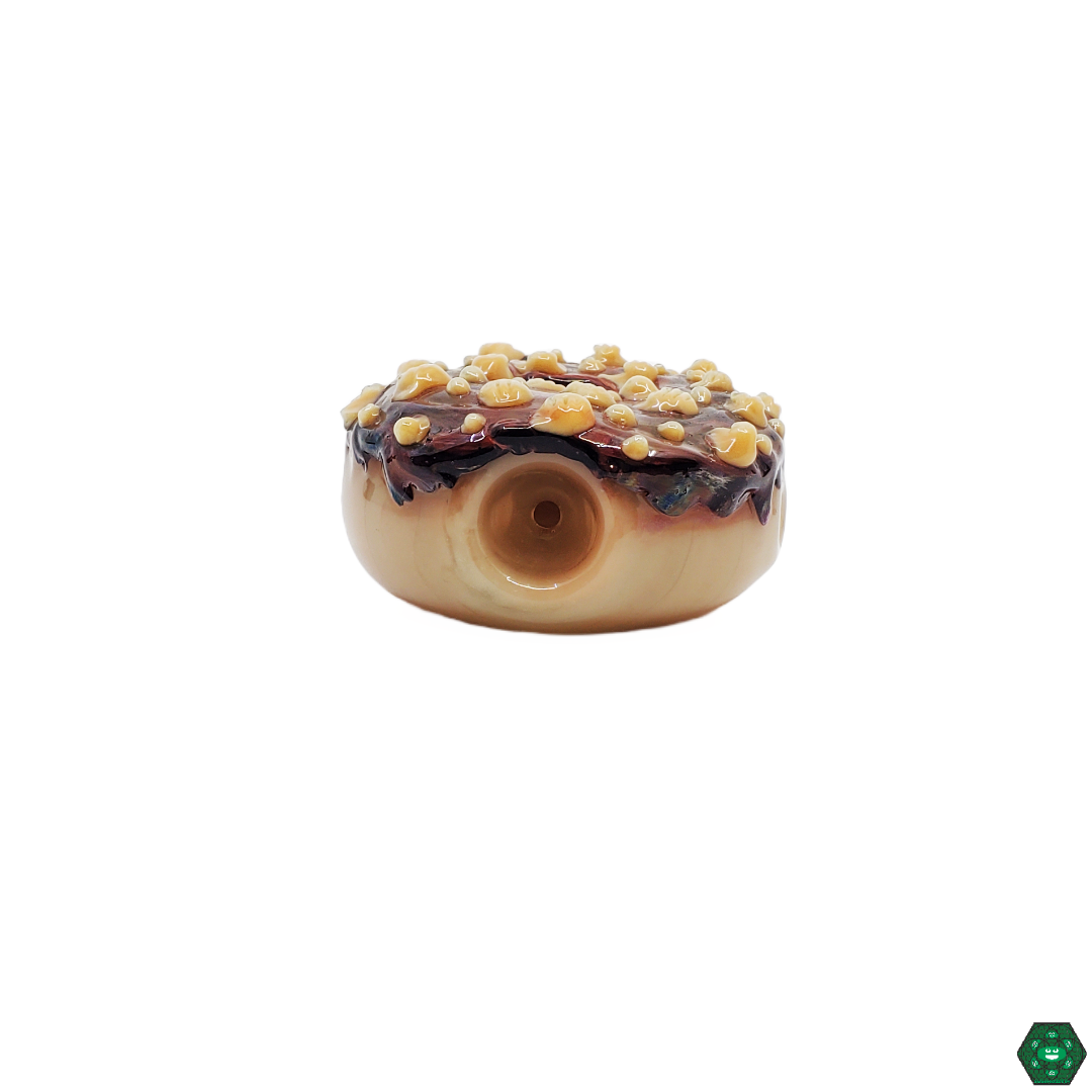 Empire Glassworks Chocolate Donut Spoon in hand, illustrating its comfortable grip and fun, collectible design for any smoking enthusiast's collection.
