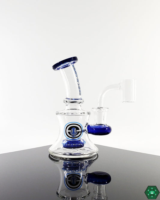  Encore Glass 5” Baby Classic Banger Hanger, a compact rig featuring a quartz nail and a 16-hole perc for smooth, filtered hits.