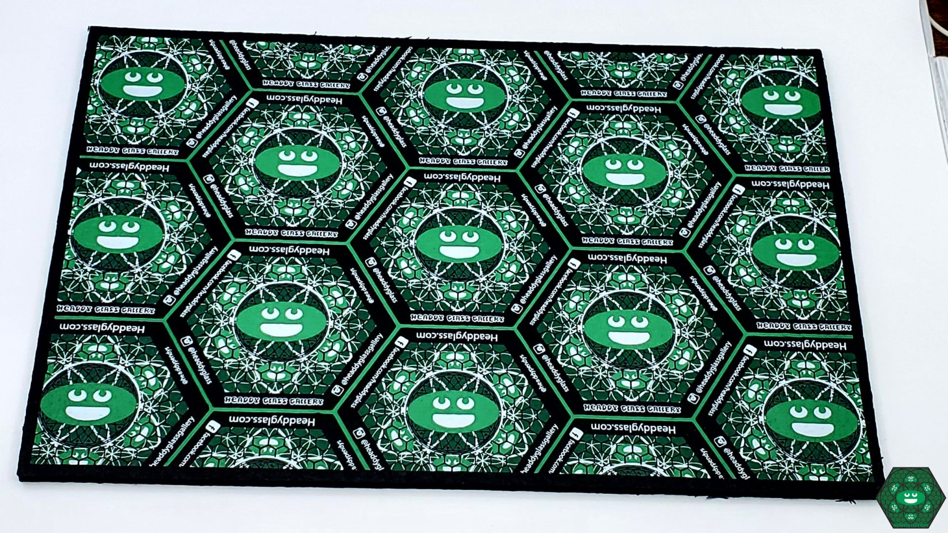  Headdy Sesh Mat, a compact and durable dab mat designed for convenience, offering a heat-resistant and non-slip surface ideal for small rigs and setups, protecting your glass pieces while adding a unique touch to your sesh area.