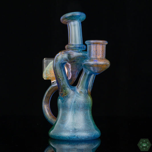 Hefe Glass Fumed Recycler, a compact, handcrafted dab rig with a beautiful fumed finish, combining artistry and performance, ensuring smooth, flavorful hits, a great choice for those seeking a unique yet functional piece.