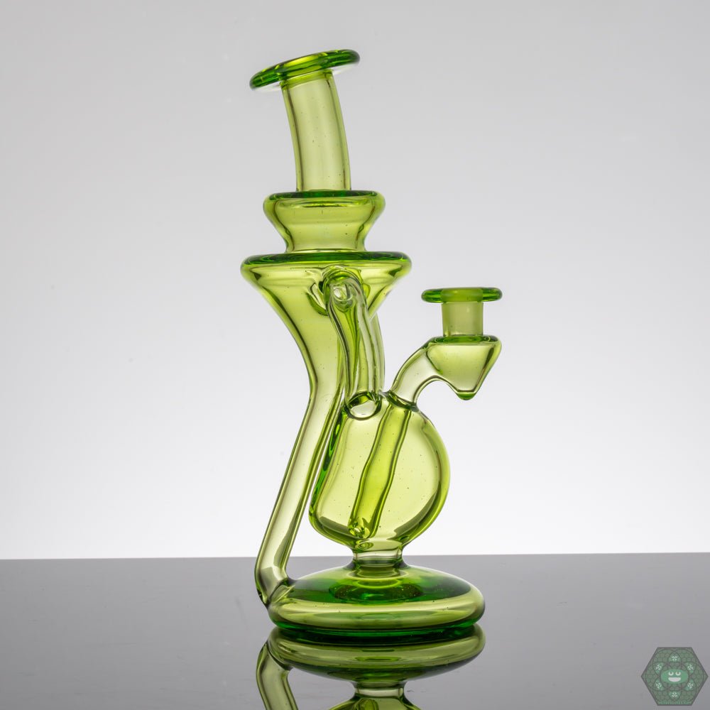  M Henny Absinthe Recycler, a 10mm dual uptake dab rig with a striking green tint, providing exceptional filtration and a smooth, flavorful pull, a top choice for those who value both performance and design.


