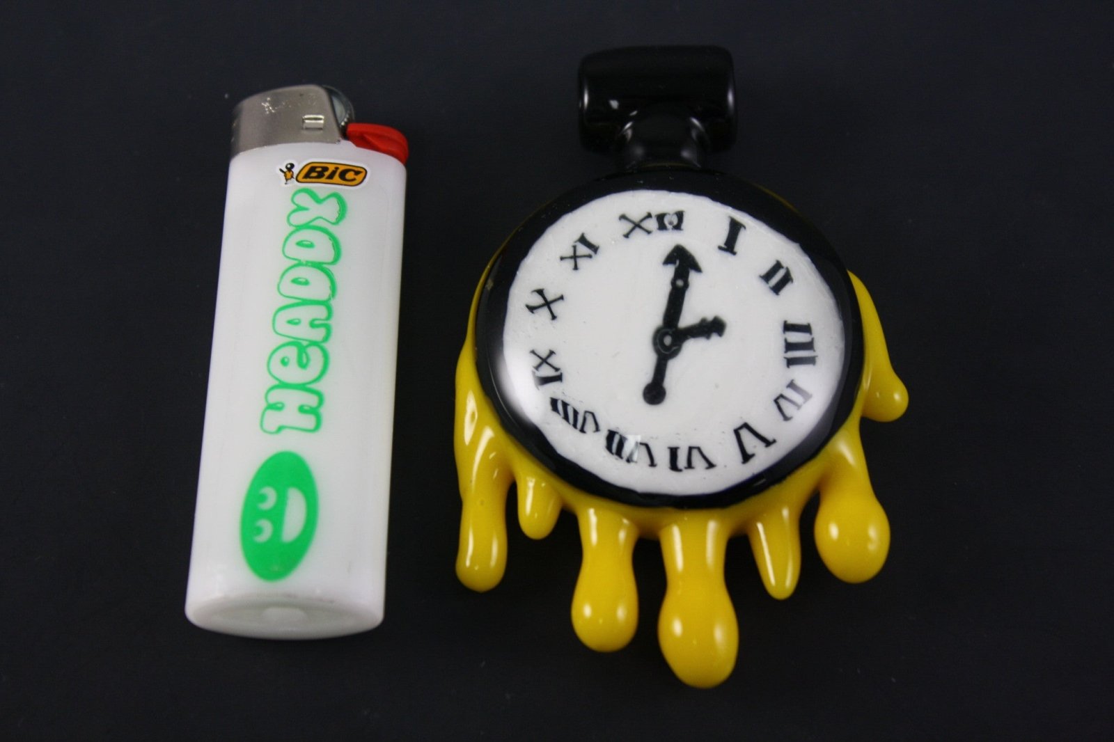 Grimm Clock Pendant, a collectible glass piece with a timepiece-inspired design, perfect for jewelry enthusiasts and collectors.