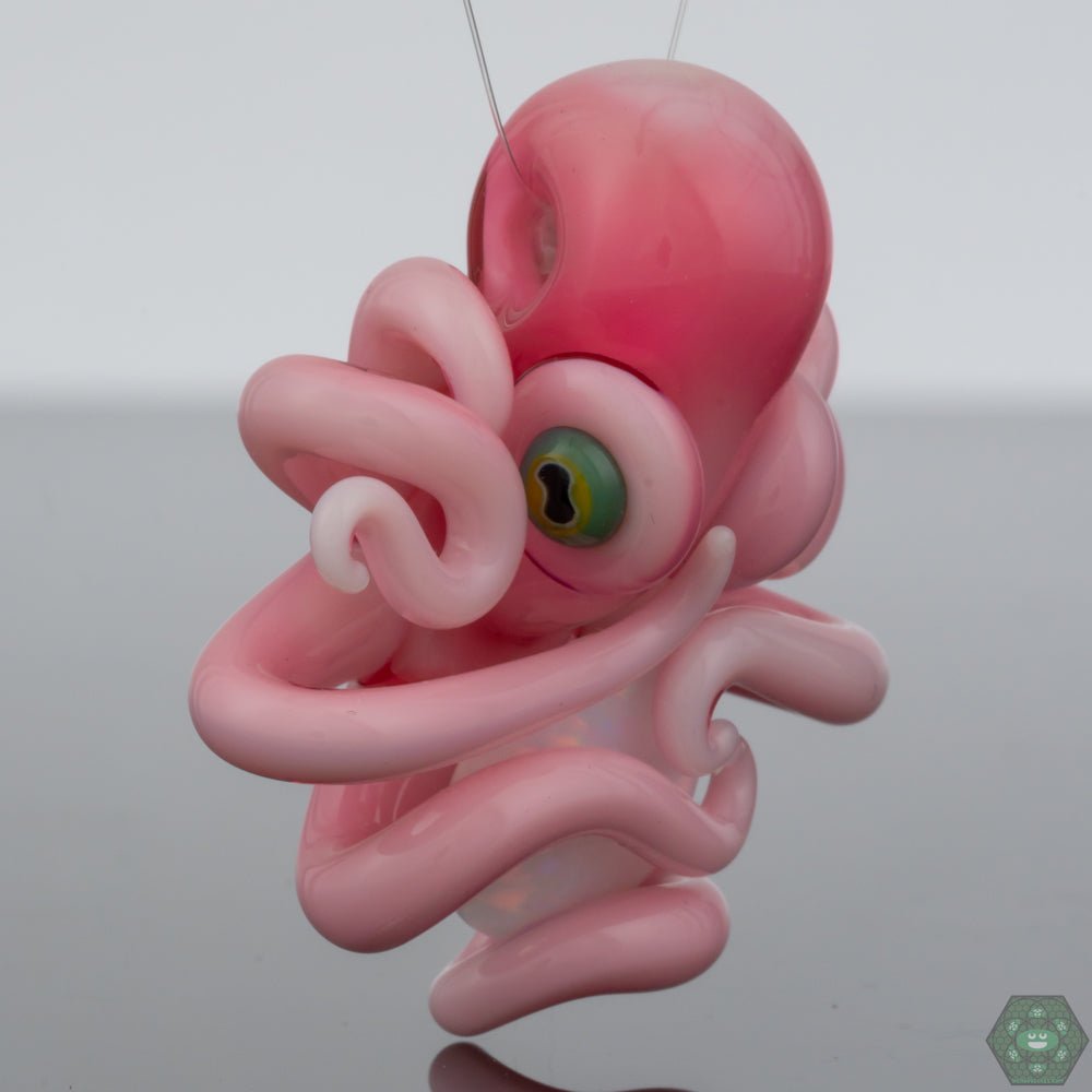 Opal Octopus Glass Pendant: This handcrafted pendant by Liz Wright showcases a beautiful opal trapped within an intricately designed octopus, creating a unique and eye-catching piece of jewelry or collectible art.