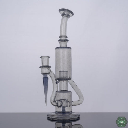 Parallax Bubble Dumper by The Glass Carpenter, a CFL reactive, premium heady glass rig featuring a 9-hole percolator, 14mm female 90-degree joint, standing at 10.75 inches, complete with a Headdy Mood Mat and a unique Parallax color shift, promising both style and performance for concentrate enthusiasts.
