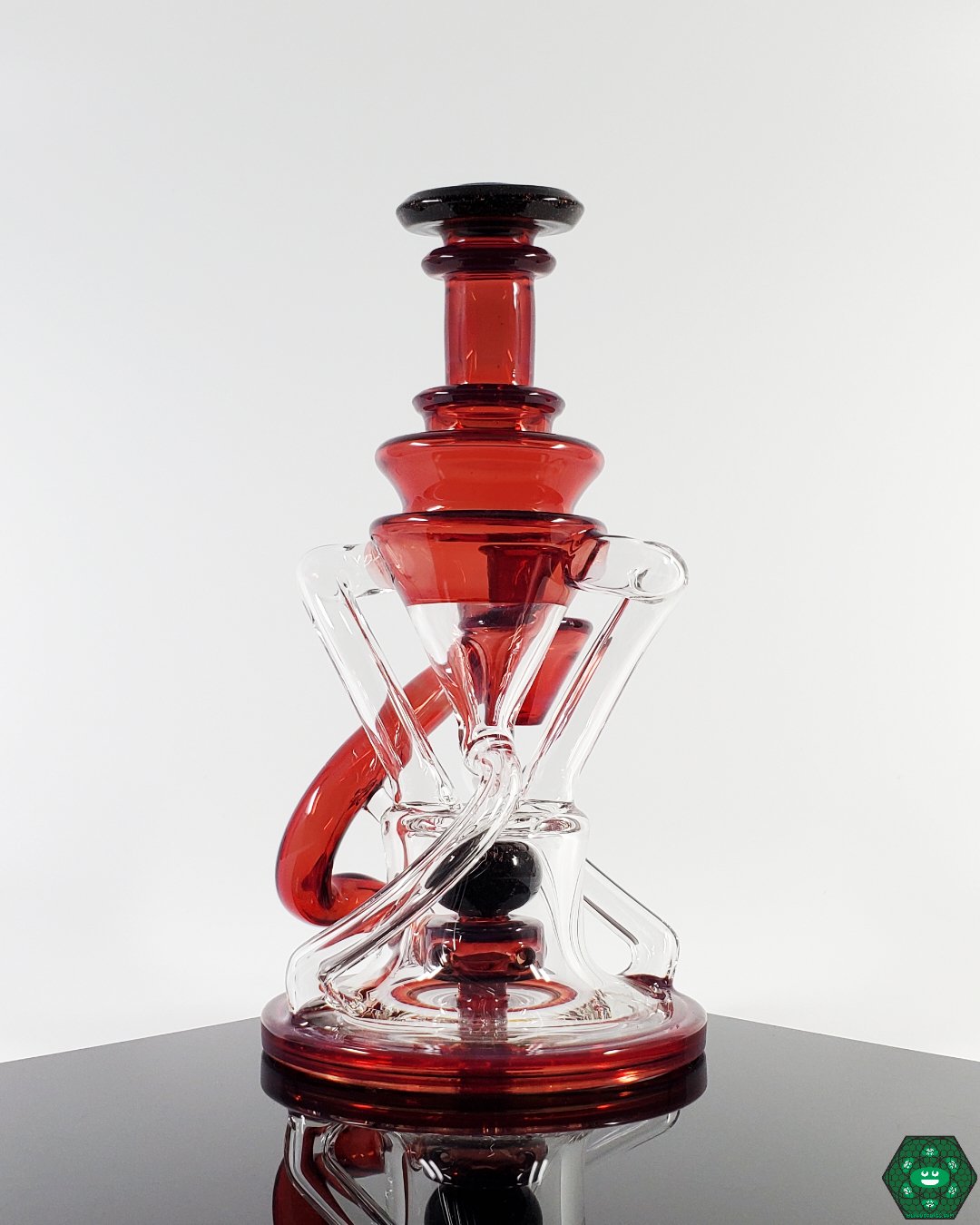 Phoenix V2 Double Recycler: The Cerio Glass Phoenix V2, offering exceptional filtration and smooth pulls with its dual uptake and 4-hole percolator, ideal for discerning collectors.


