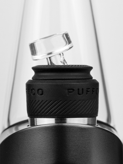  Puffco Peak Pro Ball Cap in hand, illustrating its ergonomic design and ease of use, allowing for precise airflow adjustment during each session.