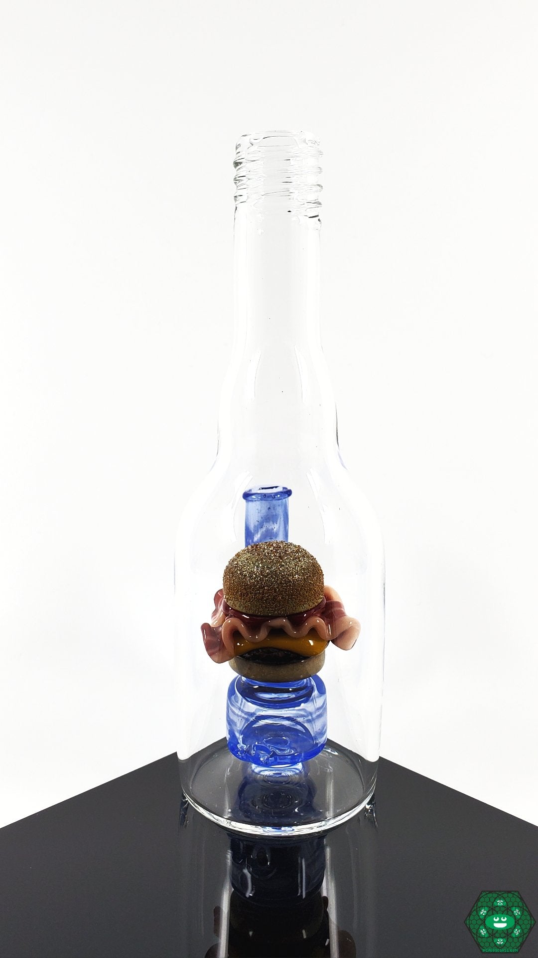 Rosburg Glass Bottle Rig Blue #1 – Compact, durable glass rig with a 10mm female joint and 2-hole perc, ideal for smooth and consistent hits.

