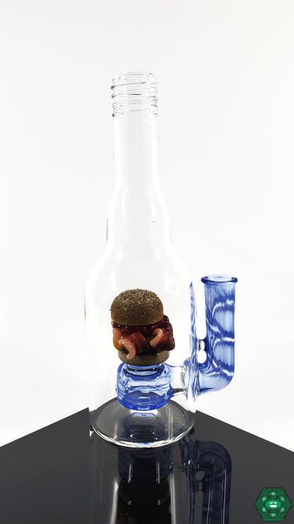 Rosburg Glass Bottle Rig Blue #1 – Collector’s item with 2-hole perc and 10mm joint, complete with a Rosburg Glass sticker and business card.

