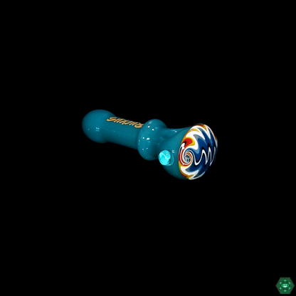 Ruckus Glass Wigwag Spoon displayed as part of a collection, highlighting its unique design and status as a collectible glass piece.