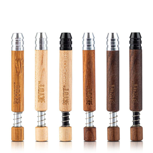  RYOT Long Wooden Spring Hitter: A close-up photo of the RYOT Long Wooden Spring Hitter, emphasizing its premium wood construction and spring-loaded ejector mechanism. The image should highlight the natural wood grain and the smooth, polished finish of the hitter. The spring-loaded ejector should be visible, suggesting its convenience and ease of use. The overall impression should be one of quality, durability, and functionality, appealing to users who value both aesthetics and performance.