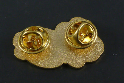 Close-up of the Slum Gold Initials Pin, showcasing its sleek design and premium enamel finish, ideal for collectors looking to showcase the brand’s identity.