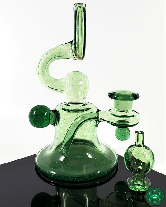 Snafu Glass Voyager Green – UV-activated glass rig with 3-hole perc, 14mm female joint, and smooth filtration for enhanced dabbing sessions.