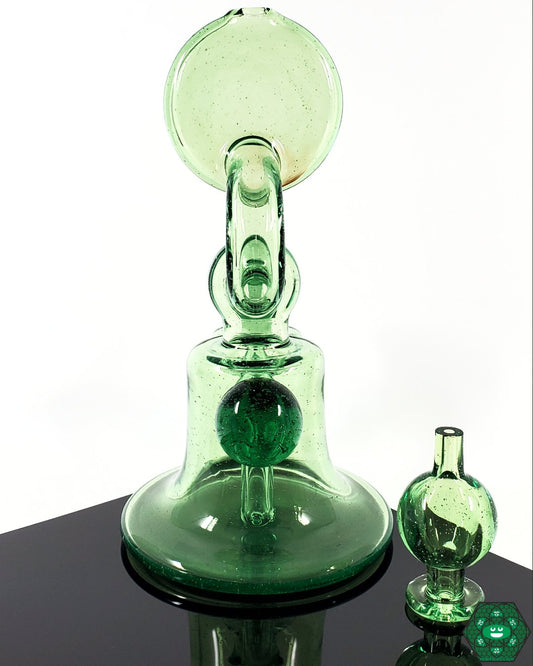 Snafu Glass Voyager Green – UV-reactive glass rig, 6.25 inches tall with 14mm female joint, glowing brilliantly under UV light for a unique experience.