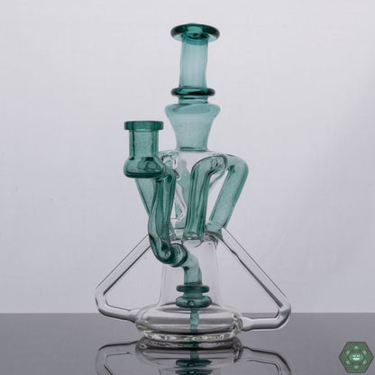 Atlantis Recycler by Spunout Glass, an ocean-inspired recycler rig merging aesthetics with peak functionality, ensuring smooth pulls and optimal filtration for an unmatched experience, featuring aquatic blue tones and an ergonomic design, a must-have for collectors and enthusiasts alike.