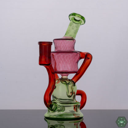 Wolfe Glass Double Single External Drain Recycler, a handcrafted 14mm dab rig with a precision external drain design, crafted from borosilicate glass for durability and aesthetic appeal, featuring a 14mm female 90-degree joint, dual uptake with single external drain for optimal airflow and superior filtration, a 4-hole perc for enhanced smoke diffusion, compact dimensions of 7.5 inches tall and 4-inch diameter, artistic color accents including Crushed Opal, Gold Ruby, Crippy, and Transparent Red, and includ