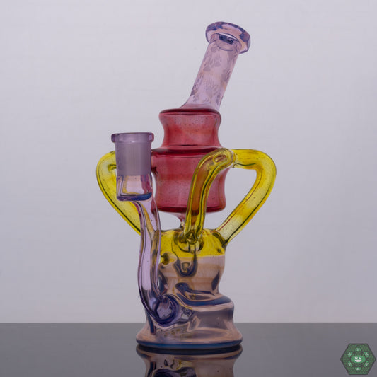 Wolfe Glass Triple Single Recycler, a 7.75" rig offering style and function with options like Phoenix Crushed Opal, Rose Quartz, Ghost, Citron, and Ghost with Crushed Opal, featuring a 4-hole perc, dual uptake, single external drain, and a faceted mouthpiece and joint, a 14mm 90-degree female rig providing powerful filtration and minimal splash, an exceptional collector’s piece for serious glass enthusiasts.